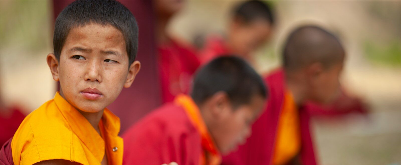 selective focus photography of boy sitting in round